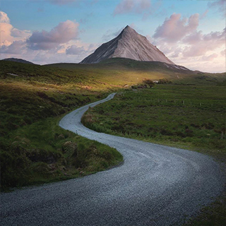 A road leading up to a mountain on the horizon.